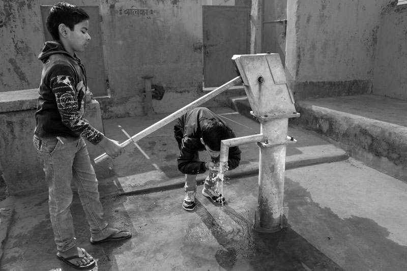 Impediments to enjoyment of Human Right to Water: 'Accessibility' Norm - student drinking arsenic-rich groundwater in a rural school in Bhojpur district, Bihar